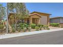 Inviting single-story residence featuring a well-manicured yard, covered porch, and an attached two-car garage at 412 Middlestone Ave, Henderson, NV 89011