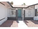 Welcoming front entrance with secure white iron gates and a vibrant blue door at 4277 Rimcrest Rd, Las Vegas, NV 89121