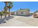 Street view of single-story home showing a long drive and desert landscaping at 4825 Stillwater Ave, Las Vegas, NV 89110