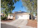 Inviting single-story home with a tile roof, two-car garage, and desert landscaping at 4848 Cutting Diamond Ct, North Las Vegas, NV 89081
