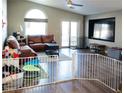 Bright living room with wood floors, vaulted ceiling, and access to the backyard at 4848 Cutting Diamond Ct, North Las Vegas, NV 89081