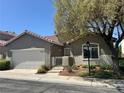 Charming single-story home features a well-maintained front yard and a two-car garage at 5600 Nimes Ave, Las Vegas, NV 89141