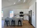 Modern kitchen featuring white cabinets, stainless steel appliances, and a breakfast bar at 5600 Nimes Ave, Las Vegas, NV 89141