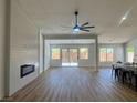 Spacious living room with modern fireplace, wood floors, and a sliding glass door to the backyard at 5600 Nimes Ave, Las Vegas, NV 89141