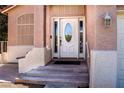 Close up of the front entry featuring decorative glass door, a light fixture, and a small bench at 6293 Pavestone Ln, Las Vegas, NV 89142