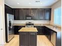 A chef's dream; this kitchen boasts stainless steel appliances, granite countertops, and hardwood floors at 664 Forest Peak St, Henderson, NV 89011