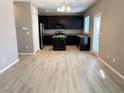 Hardwood floor, and granite countertops make this open-concept kitchen ideal for entertaining and Gathering meals at 664 Forest Peak St, Henderson, NV 89011