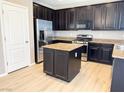 A chef's dream; this kitchen boasts stainless steel appliances, granite countertops, and hardwood floors at 664 Forest Peak St, Henderson, NV 89011