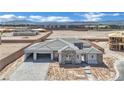 Newly constructed home features a desert landscape, with stone accents, a paved driveway and a spacious two-car garage at 7141 Painted Skyline St, Las Vegas, NV 89118