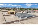An exterior view of the newly constructed home featuring a desert landscape, with backyard privacy wall at 7141 Painted Skyline St, Las Vegas, NV 89118