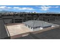 An exterior view of the newly constructed home featuring a desert landscape, with backyard privacy wall at 7141 Painted Skyline St, Las Vegas, NV 89118
