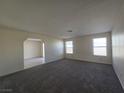 Living room features grey carpet, neutral paint, and natural light at 725 Brick Dr, Henderson, NV 89002