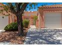 Exterior view of a single-Gathering home showing landscaping, garage, and charming entry with a security gate at 731 Appletree Ln, Mesquite, NV 89027