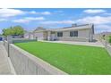 Beautifully landscaped front yard with green grass complementing the charming single-story home at 808 Vermillion Dr, Henderson, NV 89002