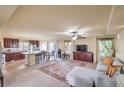 Open-concept living room features a comfortable sofa, ceiling fan, and lots of natural light at 8316 Accolade St, Las Vegas, NV 89139