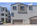 Charming townhome with attached garage, multi-paned windows, and neutral stucco at 8436 Noir Ave, Las Vegas, NV 89129