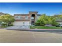 Attractive two-story home features a three-car garage and well-manicured front yard at 8812 Glenistar Gate Ave, Las Vegas, NV 89143
