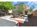 Two-story home with a well-manicured front yard, a covered entryway and an attached two-car garage at 9004 Harbor Wind Ave, Las Vegas, NV 89178