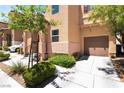 A close up of a well-maintained home with manicured landscaping and attached garage at 9112 Picturesque Ave, Las Vegas, NV 89149
