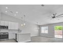Open floor plan featuring a modern kitchen, stainless appliances, and lots of natural light at 918 Ambusher St, Henderson, NV 89014