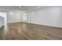 Spacious living room boasts wood-look tile flooring and neutral paint at 10325 Quartz Reef Ct, Las Vegas, NV 89141