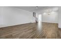 Bright living room with wood-look tile floor and open staircase at 10325 Quartz Reef Ct, Las Vegas, NV 89141