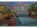 Dusk view of a two-story home with a gray garage, tidy landscaping, and a charming stone-accented entrance at 10623 Kearney Mountain Ave, Las Vegas, NV 89166
