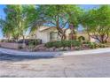 Corner lot property with mature trees and manicured landscaping and charming exterior paint at 1897 Holdenville St, Henderson, NV 89052