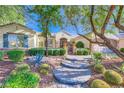 Inviting single-story home with desert landscaping, a decorative gate, and a stone-accented facade at 1897 Holdenville St, Henderson, NV 89052