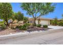 Attractive single story home featuring a three-car garage, mature trees and desert landscaping in a suburban neighborhood at 2016 Biloxi Pass, Henderson, NV 89052