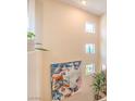 Staircase featuring artwork and small windows offering natural light to the stairway at 2050 W Warm Springs Rd # 1923, Henderson, NV 89014