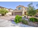 Charming two-story home featuring a two-car garage and a well-maintained front yard with green bushes at 210 Red Sandstone Ave, North Las Vegas, NV 89031