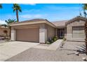 Well-maintained single-story home with a two-car garage, desert landscaping and a secure gated entry at 2118 High Mesa Dr, Henderson, NV 89012