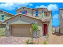Inviting two-story home featuring a red door, neutral siding, and a well-manicured front yard at 2728 Tricase St, Henderson, NV 89044