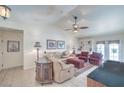Comfortable living room featuring plush seating, a ceiling fan, and tile floors at 2738 Sandalwood Ave, Henderson, NV 89074