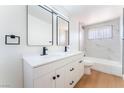 Modern bathroom features double sinks, large mirrors, and a shower-tub combination at 2878 El Cajon St, Las Vegas, NV 89169