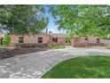 Inviting single-story home with mature trees, a circular driveway, and manicured landscaping at 3753 Meadowcrest Dr, Las Vegas, NV 89121