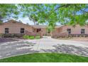 Inviting single-story home with mature trees, a circular driveway, and manicured landscaping at 3753 Meadowcrest Dr, Las Vegas, NV 89121