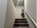 Carpeted staircase leading to the upper level with a white handrail at 4337 Stardusk Falls Ave, North Las Vegas, NV 89084