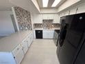 Updated kitchen features a breakfast bar, quartz countertops, white cabinets and stainless appliances at 435 Mesa Blvd # 202, Mesquite, NV 89027