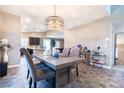 Open-concept dining area featuring a modern chandelier and stylish decor at 4376 Latitude Valley Ct, North Las Vegas, NV 89084