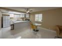 Open concept kitchen with white cabinetry, stainless steel appliances, and breakfast bar seating at 4420 Rich Dr # B, Las Vegas, NV 89102