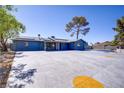 Beautiful home with solar panels, large driveway, complemented by mature landscaping at 4490 W Warm Springs Rd, Las Vegas, NV 89118
