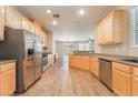 Bright kitchen features stainless steel appliances, wood cabinets and modern recessed lighting at 455 Westminster Hall Ave # 101, North Las Vegas, NV 89032