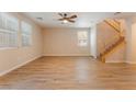 Spacious living area with stylish flooring, large windows, and a staircase with wood railing at 455 Westminster Hall Ave # 101, North Las Vegas, NV 89032