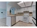 Bright kitchen featuring white cabinetry, tile backsplash, and stainless steel appliances at 4742 Obannon Dr # A, Las Vegas, NV 89102