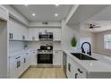 Contemporary kitchen with white cabinetry, stainless steel appliances, and a stylish black faucet at 555 E Silverado Ranch Blvd # 2129, Las Vegas, NV 89183