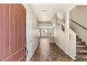 Bright entryway with tile flooring, staircase, and natural light streaming in at 6014 Belvedere Canyon Ave, Las Vegas, NV 89139