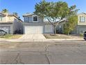 Charming two-story home with a well-maintained front yard and a two-car garage at 6063 Peach Orchard Rd, Las Vegas, NV 89142