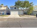 Beautiful two-story home with a well-kept front yard and a convenient two-car garage. Desert landscaping at 6063 Peach Orchard Rd, Las Vegas, NV 89142